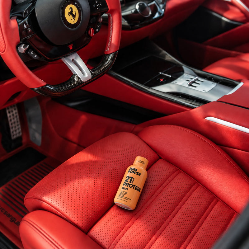 A SUPA POWER shot in a car cupholder with a gym bag, ready on the go